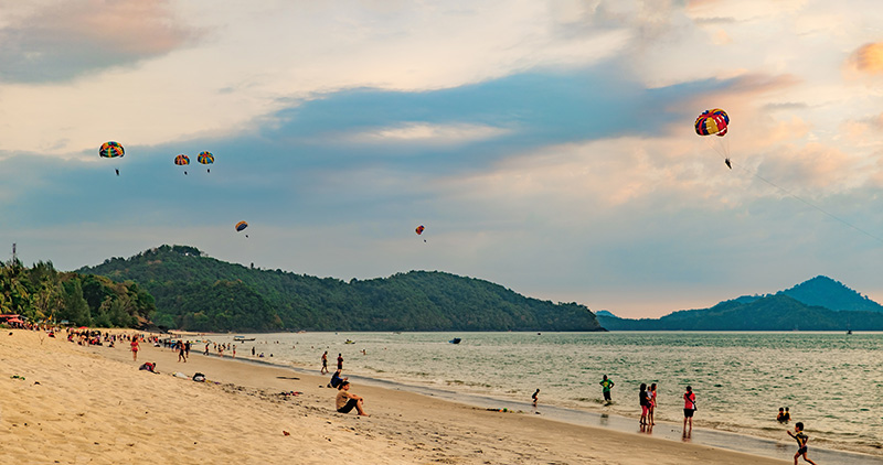 Paragliders at sunset on Pantai Tengah,in Langkawi, Malaysia